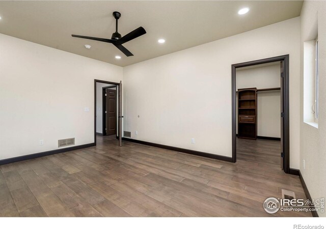 unfurnished bedroom featuring visible vents, recessed lighting, baseboards, and wood finished floors