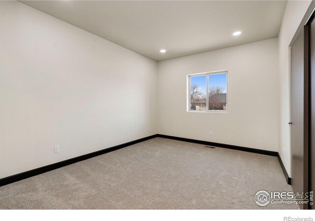 unfurnished bedroom with carpet flooring, recessed lighting, visible vents, and baseboards