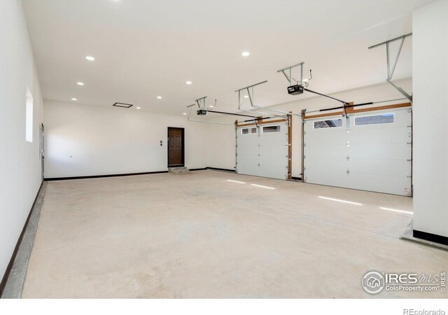 garage with recessed lighting and a garage door opener