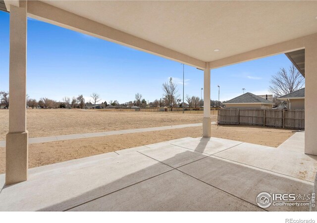 view of patio / terrace featuring fence