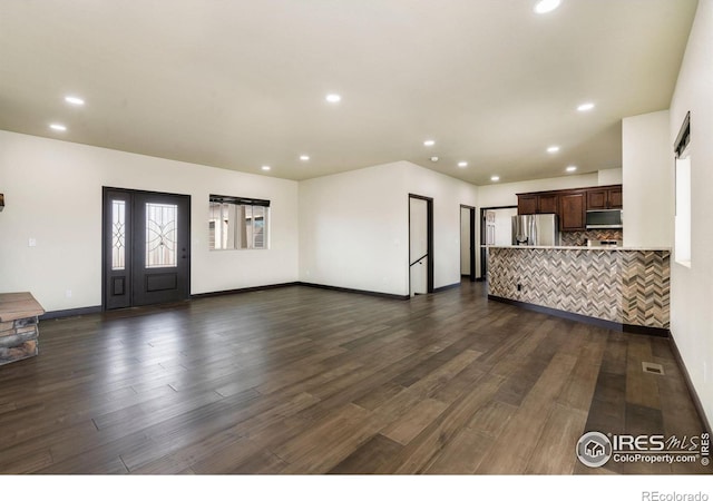 unfurnished living room featuring dark wood finished floors, visible vents, recessed lighting, and baseboards