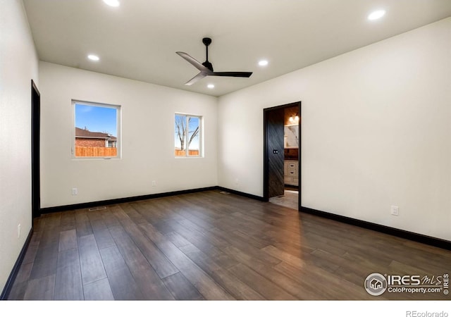 spare room featuring recessed lighting, baseboards, and wood finished floors