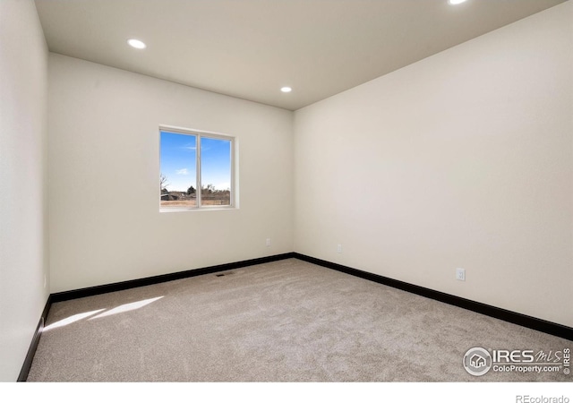 unfurnished room with recessed lighting, baseboards, and carpet