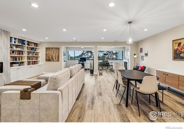 living area featuring light wood finished floors and recessed lighting