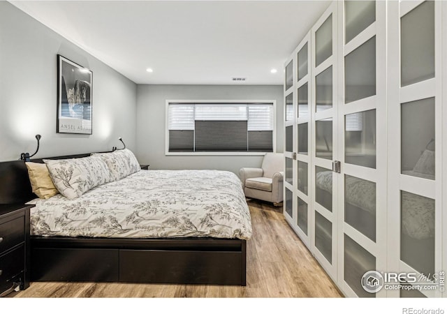 bedroom with light wood-type flooring, visible vents, and recessed lighting