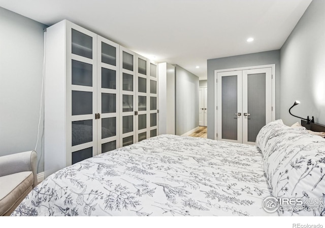 bedroom with a closet, recessed lighting, and french doors