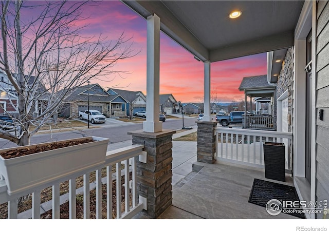 view of patio featuring a porch and a residential view