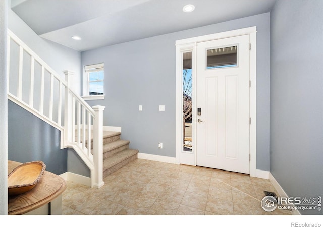 entryway with tile patterned floors, stairs, baseboards, and recessed lighting