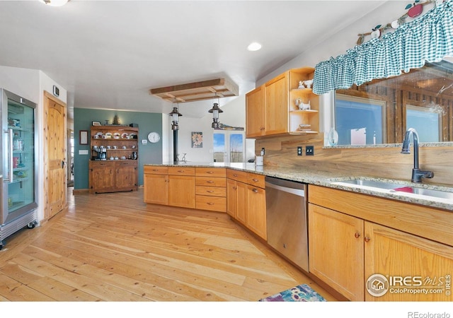 kitchen with open shelves, stainless steel dishwasher, light wood-style floors, a sink, and a peninsula