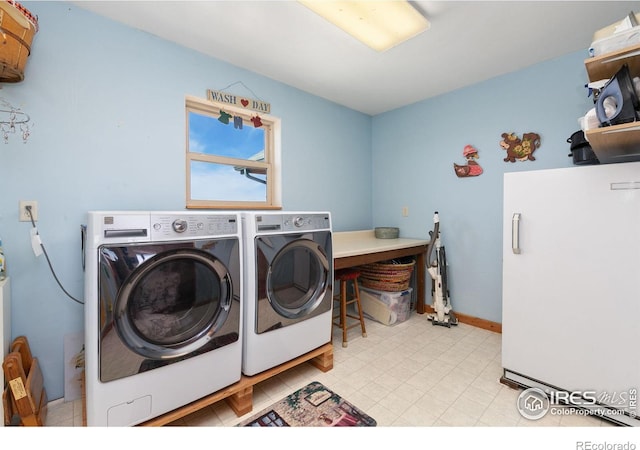 laundry area featuring laundry area, independent washer and dryer, and baseboards