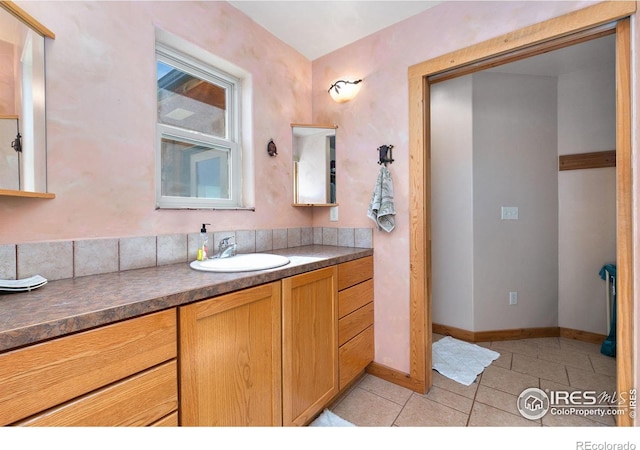 bathroom featuring baseboards, vanity, and tile patterned floors