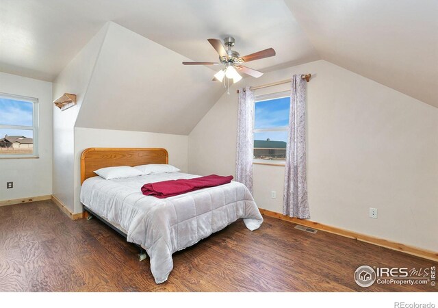 bedroom featuring visible vents, vaulted ceiling, multiple windows, and wood finished floors