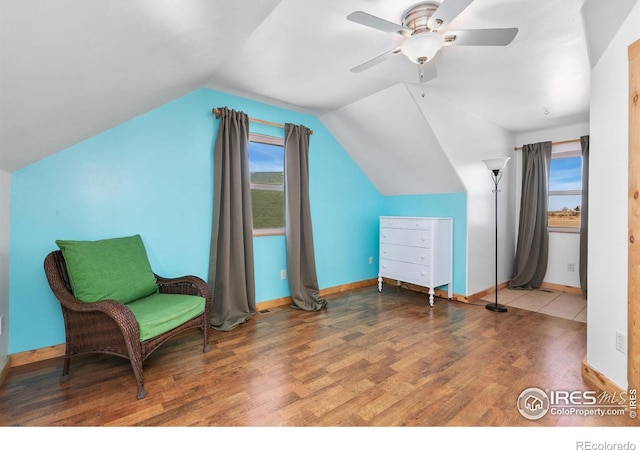 sitting room featuring ceiling fan, vaulted ceiling, baseboards, and wood finished floors