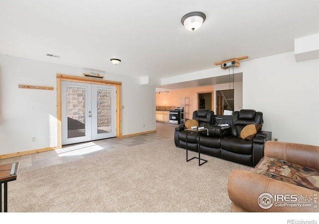 carpeted living room featuring french doors, visible vents, and baseboards