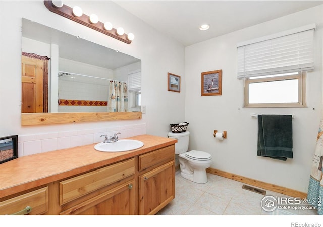 bathroom featuring visible vents, a shower with shower curtain, toilet, tile patterned floors, and vanity