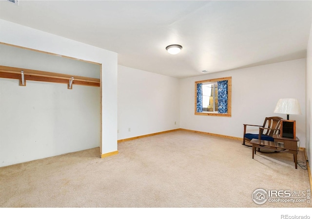 sitting room with carpet, visible vents, and baseboards