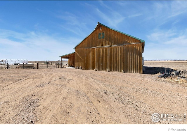 view of outbuilding with fence and an outdoor structure