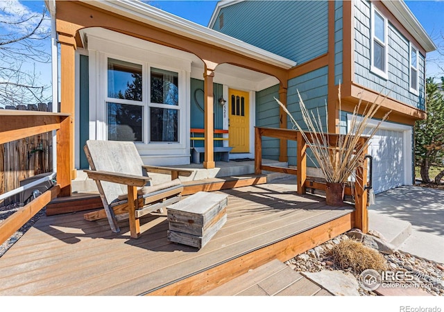 wooden deck with an attached garage and covered porch