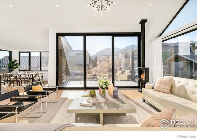 2586 3rd St, Boulder, CO 80304 - living area featuring wood finished floors, a chandelier, a mountain view, and expansive windows