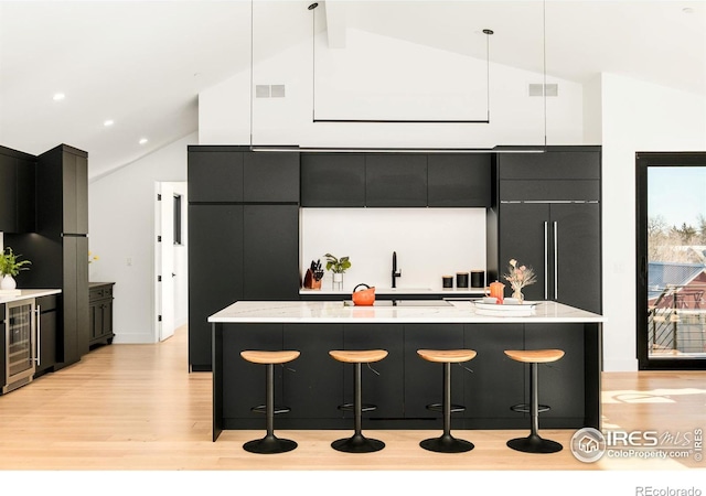 2586 3rd St, Boulder, CO 80304 - kitchen featuring modern cabinets, beverage cooler, light wood finished floors, a sink, and dark cabinetry