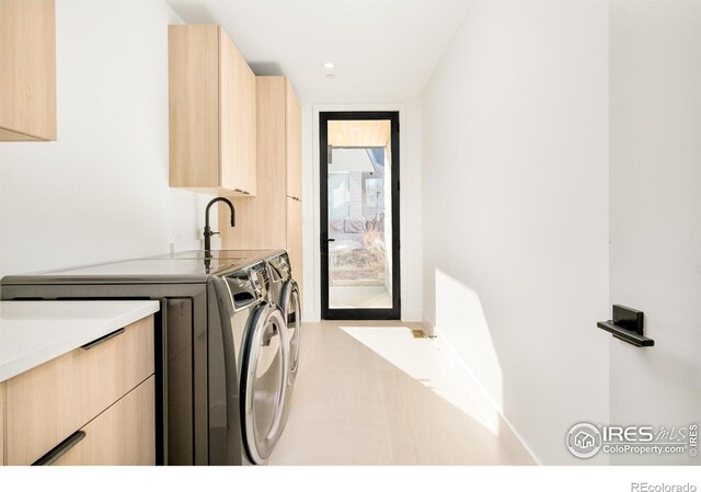2586 3rd St, Boulder, CO 80304 - laundry room with washing machine and dryer, cabinet space, and baseboards