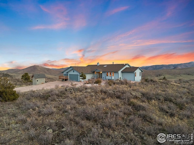 view of front of property featuring a mountain view, driveway, and an attached garage