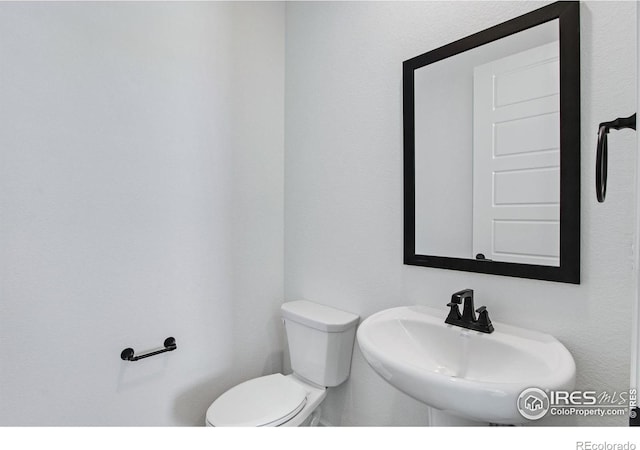 bathroom with toilet and a sink