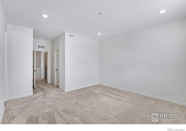 empty room with baseboards, carpet floors, visible vents, and recessed lighting