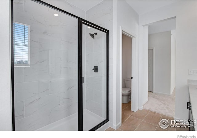 full bathroom with tile patterned flooring, a shower stall, toilet, and baseboards