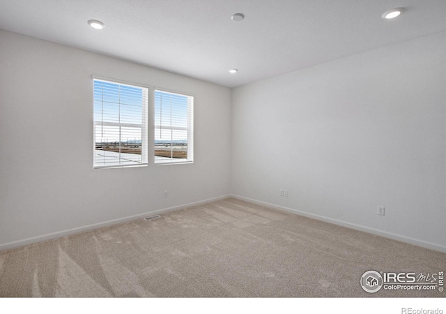 carpeted spare room featuring recessed lighting and baseboards