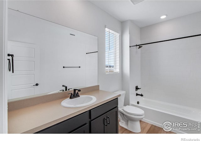 full bath featuring tub / shower combination, vanity, toilet, and wood finished floors