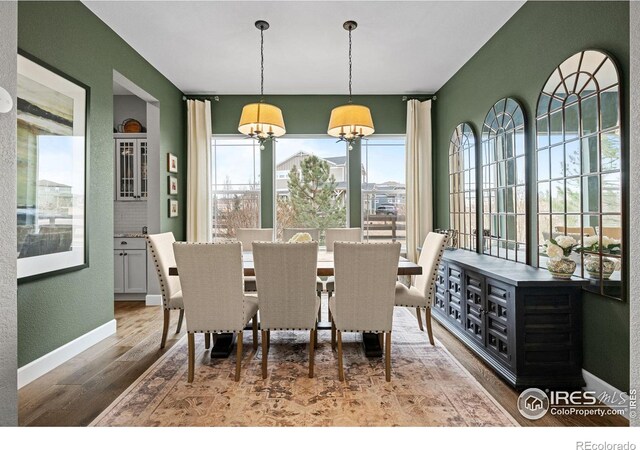 dining area with wood finished floors and baseboards