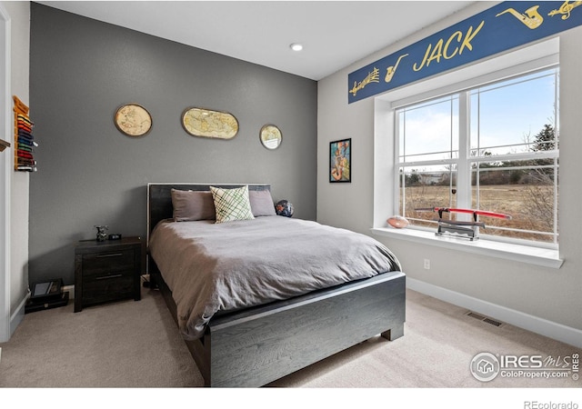 bedroom featuring baseboards, visible vents, and carpet flooring