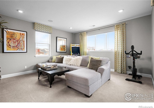 living area featuring carpet, baseboards, and recessed lighting