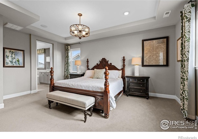 carpeted bedroom with baseboards, a tray ceiling, visible vents, and a notable chandelier