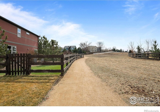 view of road with a rural view and dirt driveway