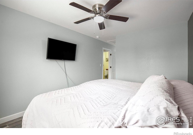 bedroom with baseboards, a ceiling fan, and wood finished floors