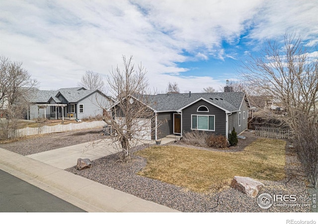 single story home featuring a garage, fence, driveway, roof with shingles, and a front lawn