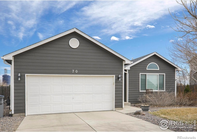 ranch-style home with a garage and driveway