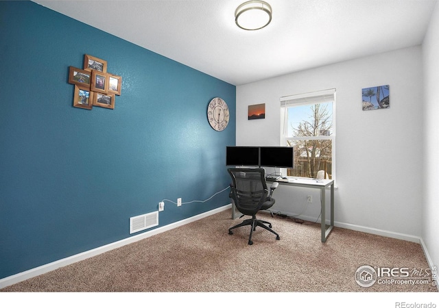 home office with carpet floors, baseboards, and visible vents