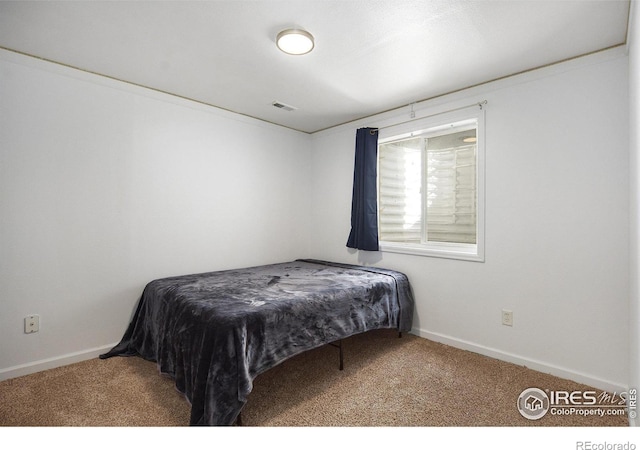 bedroom with visible vents, baseboards, and carpet flooring