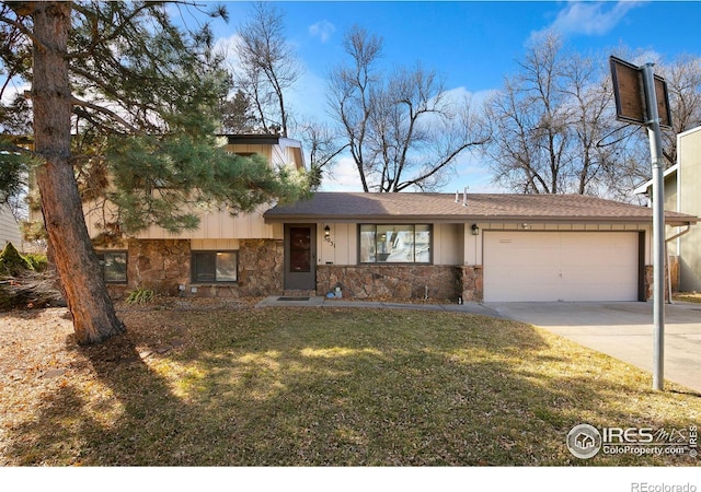 split level home with stone siding, concrete driveway, a garage, and a front yard