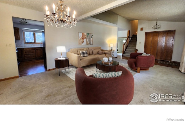 living area with a textured ceiling, lofted ceiling, a notable chandelier, stairs, and carpet