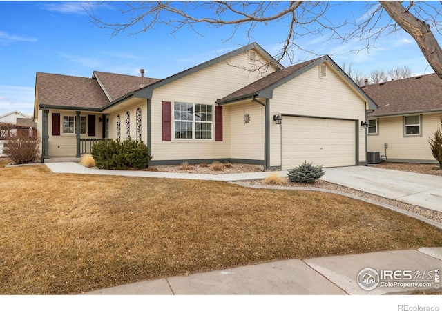 ranch-style house with a porch, a front yard, concrete driveway, and an attached garage