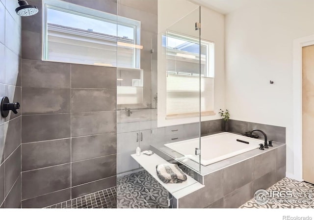 5626 Four Leaf Dr, Longmont, CO 80503 - bathroom with a tile shower, a bath, and tile patterned floors