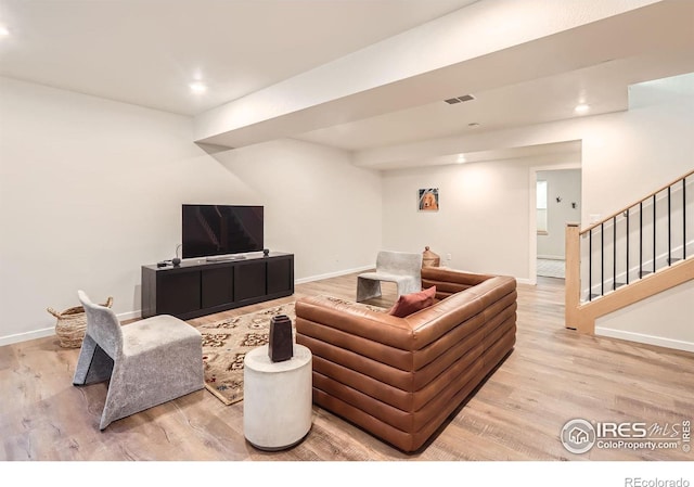 5626 Four Leaf Dr, Longmont, CO 80503 - living room featuring light wood-style floors, stairs, baseboards, and recessed lighting