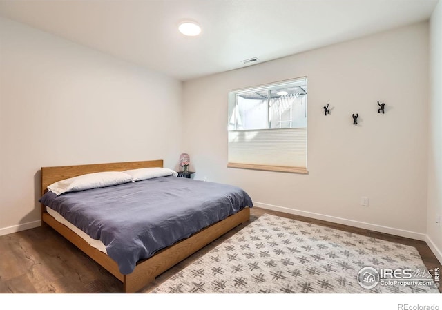 5626 Four Leaf Dr, Longmont, CO 80503 - bedroom featuring baseboards and wood finished floors
