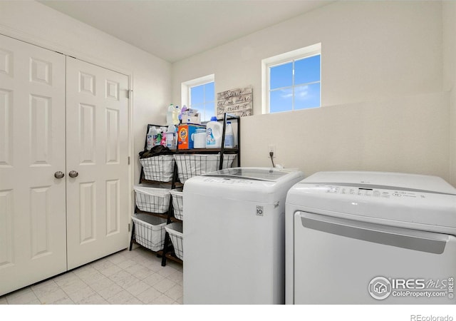 washroom featuring washing machine and dryer and laundry area