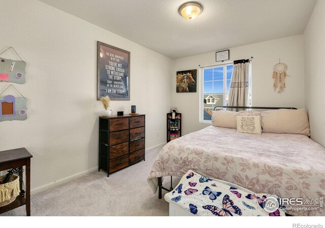 bedroom featuring carpet floors and baseboards