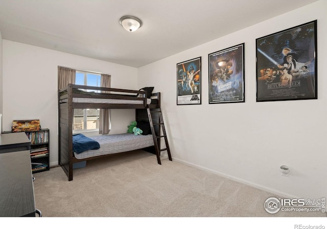 carpeted bedroom featuring baseboards